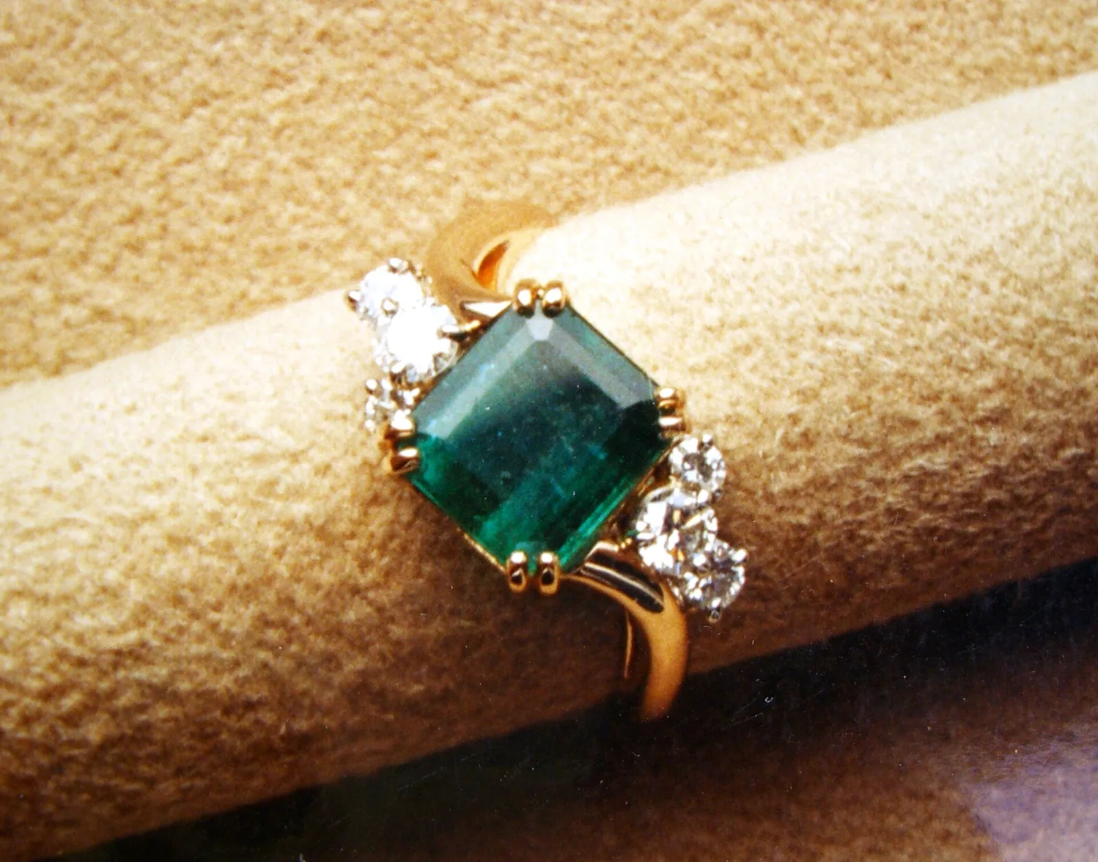 An emerald and diamond three-stone ring